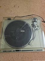 Top view of Pioneer PL-200 turntable with closed dust cover showing scratches and attached power cord