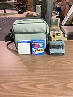 Camera, film, bag, manual on table