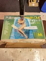 Front of retail box showing Pollenex Health Club Whirlpool Bath graphics and AA power indicator