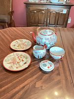 Full group view of porcelain tea set on table