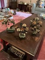 All three porcelain bonsai sculptures on coffee table