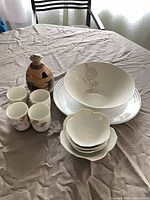 Full lot overview showing bowl, plate, cups, scalloped bowls and jar