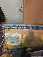 Damaged shipping carton with swing cushion visible