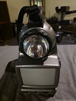 Front view showing flashlight lens and screen