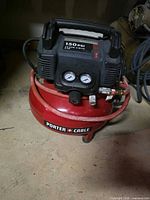 Full view of Porter-Cable pancake air compressor with hose attached