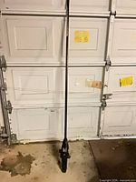 Full view of Poulan Pro pole pruner standing upright showing overall length