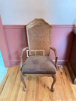 Full front view of wood armchair showing overall design, cabriole legs, armrests and upholstered seat