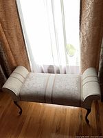 Full view of upholstered bench in front of window
