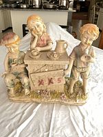 Front view of complete resin figurine showing three children around lemonade stand and overall condition