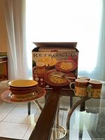 Box showing Retronel Villa Florentine branding with several pieces displayed on table