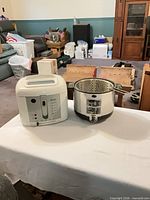 Rival and Sunbeam deep fryers side by side showing overall condition and accessories