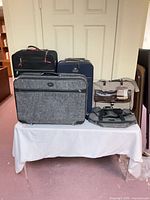 Five luggage pieces set on table for overview