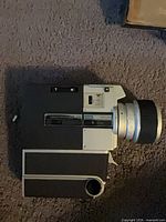 Left side profile of Sankyo Super CM camera showing lens and controls