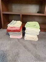 Two stacks of assorted colored hand towels