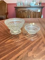 Both pressed glass bowls on table