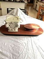 Large wooden riser with ceramic pedestal and small riser on top