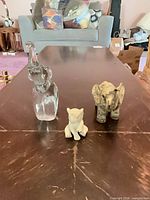 Group shot of three animal figurines on table