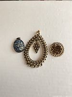 All three pendants laid out for size and style overview