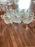 Six clear glass cordial cups grouped on tabletop