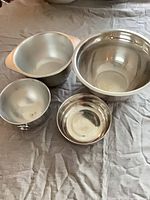 All four bowls grouped to show sizes and materials
