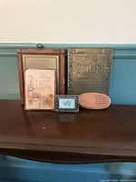 Group view of all five plaques showing relative sizes and materials