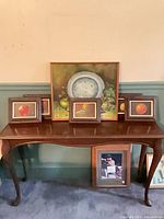 All six framed paintings displayed on table