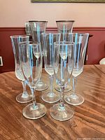 Group shot showing all seven crystal champagne flutes on table