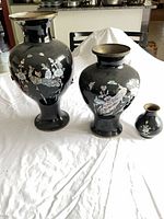 All three black ceramic vases displayed together