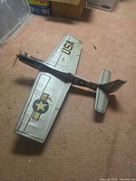 Top view of full model airplane showing silver covering, USA markings, star roundel, fixed landing gear
