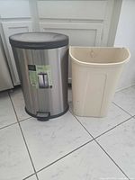 Front view of both trash cans showing size, materials, and color