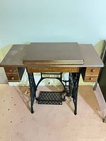 Closed cabinet showing overall treadle sewing machine unit