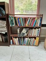 Front view of wooden bookcase loaded with books