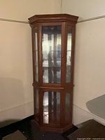 Full view of corner curio cabinet closed