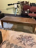 Coffee table front perspective showing overall shape and leg style
