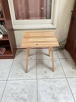 Side table front view showing slatted top and legs