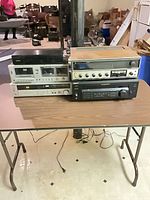 Group view showing Sony STR-DE435 and Kenwood KR-5150 stacked with other equipment (other gear not included)