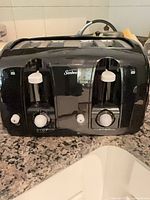 Front view showing Sunbeam branding, levers, dials, cancel buttons