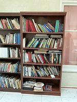 Front view of brown MDF bookcase filled with books