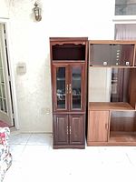 Front view of cabinet closed showing glass upper door and solid lower doors