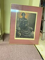 Full view of framed print standing against wall