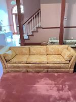 Front view of yellow-gold jacquard sofa showing overall style and condition