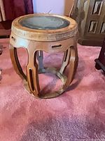 Full view of stool showing openwork sides and marble top