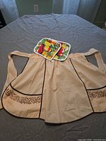 Apron front with pot holders displayed on waistband