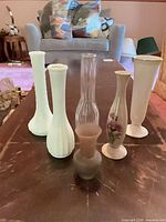 All six bud vases grouped on table