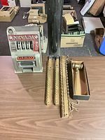 Slot machine, three wooden tie racks, gavel in box on table