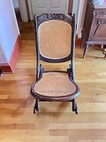 Front view showing cane seat and back, overall construction