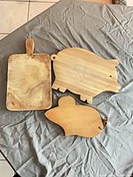 Front view of all three wooden boards showing overall design and wear