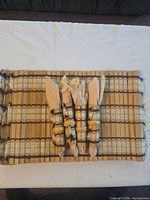Four napkins with rings placed on top of stacked placemats showing material and pattern