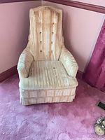 Front view of yellow velvet wingback armchair