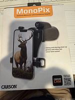 Front of sealed retail box showing Carson MonoPix 10x42mm Monocular with Smartphone Adapter